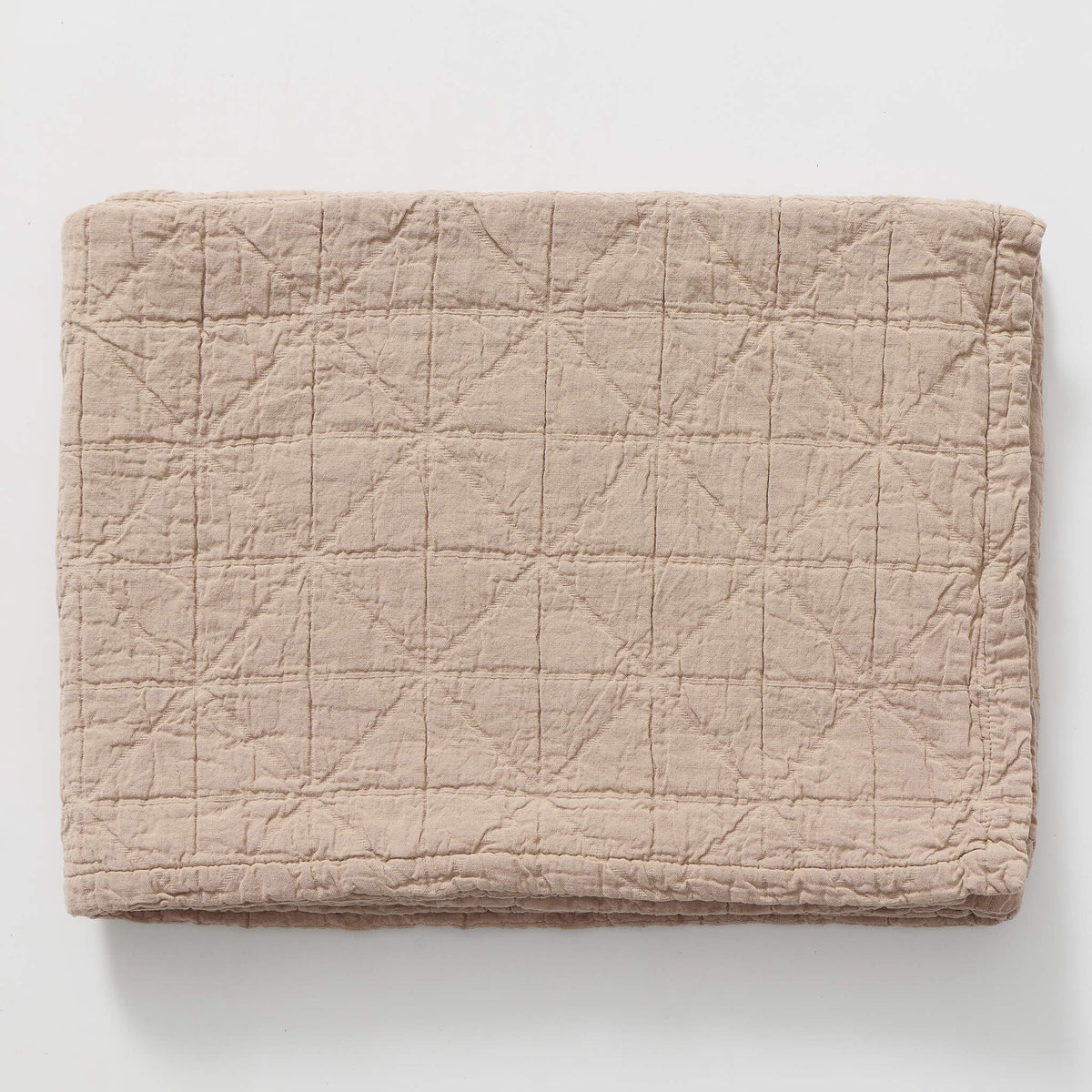 Soft rose pink cotton jacquard textured blanket on a white background