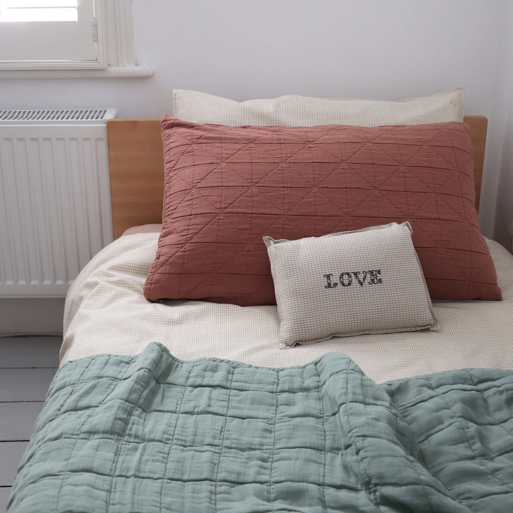 Square quilted blanket in sage 100% soft cotton gauze and lightly filled with anti-allergy polyester comes in 4 different sizes bedding by camomile london